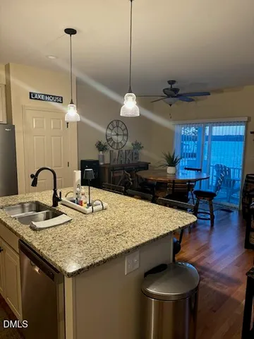 a kitchen with a counter space cabinets and wooden floor