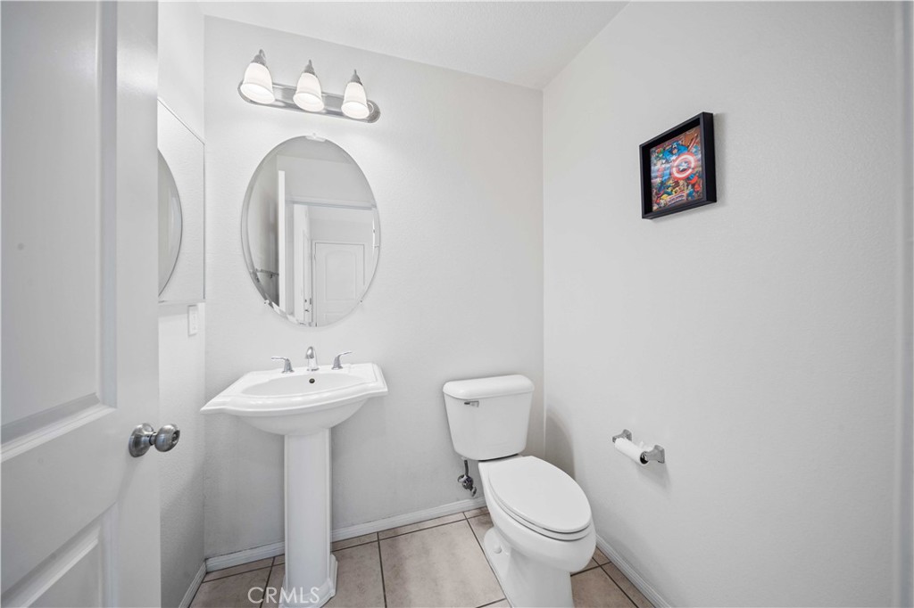 9352 Condor Court Pacoima, CA 91331 - Photo 11 of 23 a bathroom with a toilet sink and mirror