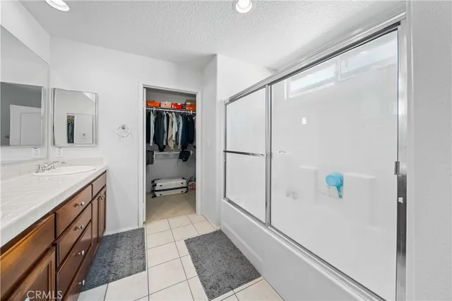 a bathroom with a shower and a sink