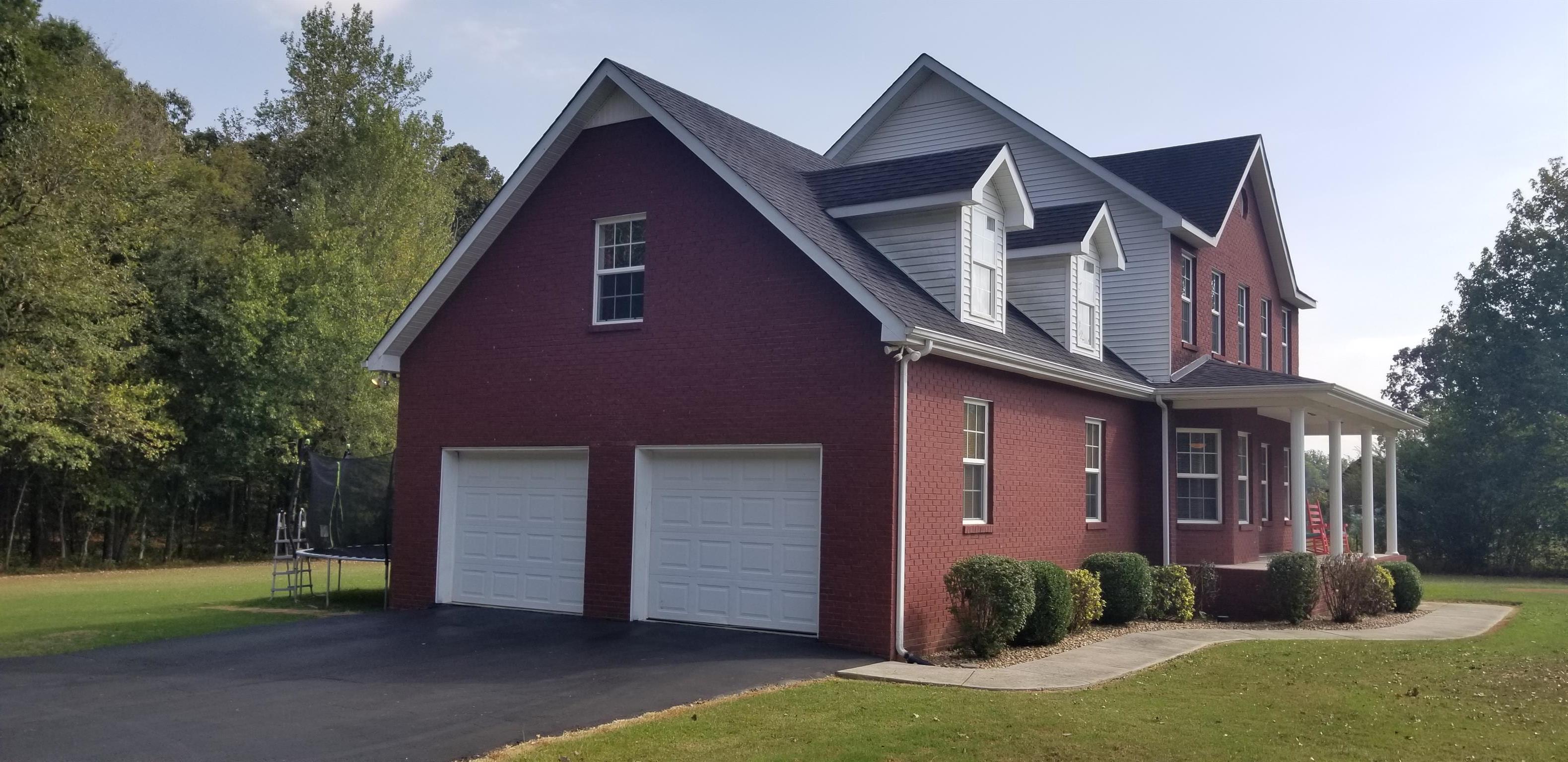 3046 Wayside Road Manchester, TN 37355 - Photo 2 of 30 a front view of a house with a yard and garage