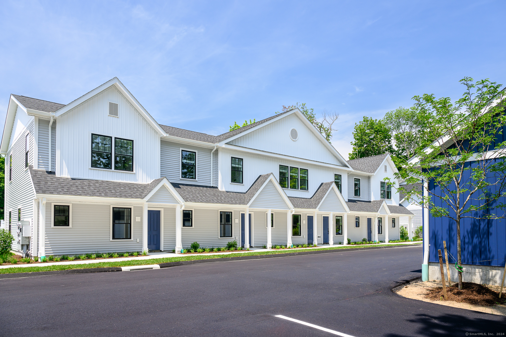 138 Boston Post Road, Unit 8 East Lyme, CT 06333 - Photo 1 of 1 a front view of a house with a garden