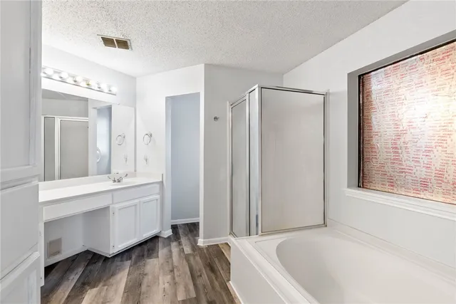 a bathroom with a bathtub and a shower