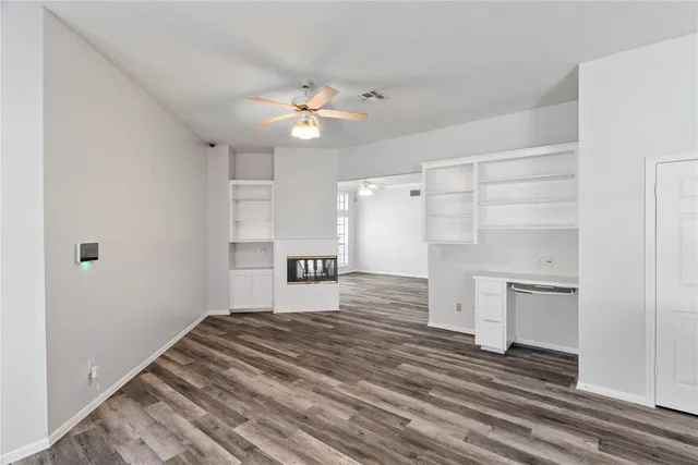 a bedroom with a bed and a ceiling fan