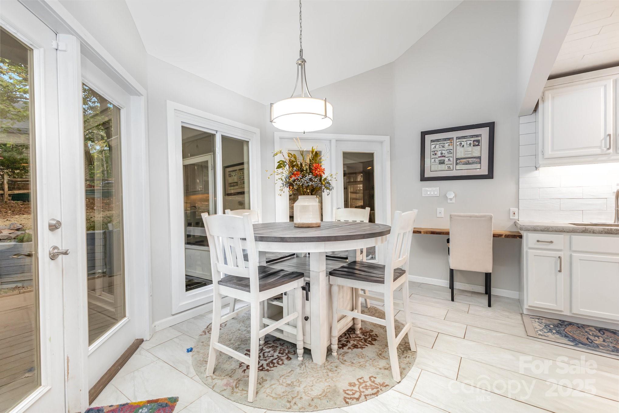7042 Chelsea Day Lane Tega Cay, SC 29708 - Photo 11 of 40 a view of a dining room with furniture window and outside view