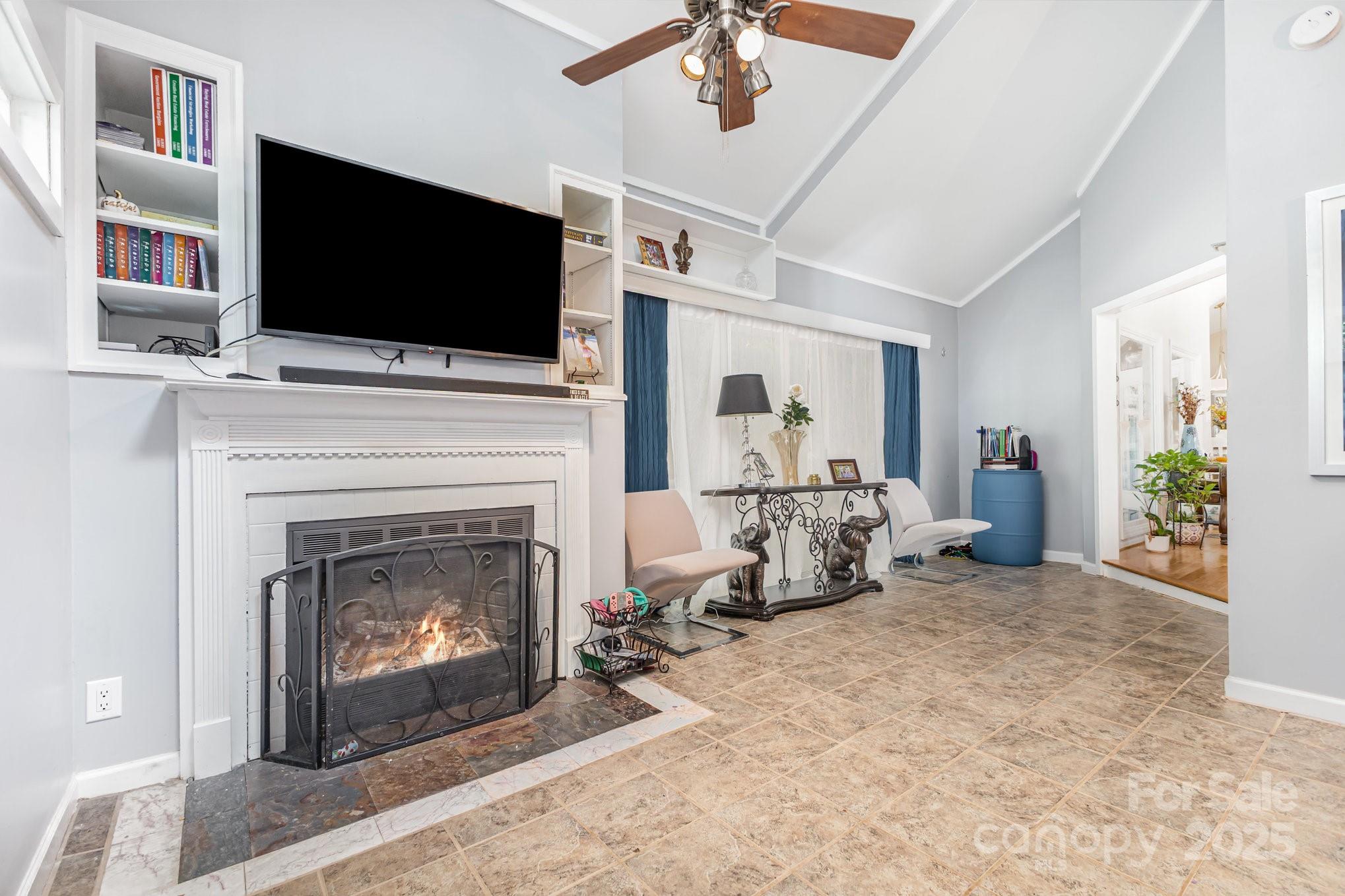 7042 Chelsea Day Lane Tega Cay, SC 29708 - Photo 13 of 40 a living room with fireplace and a flat screen tv