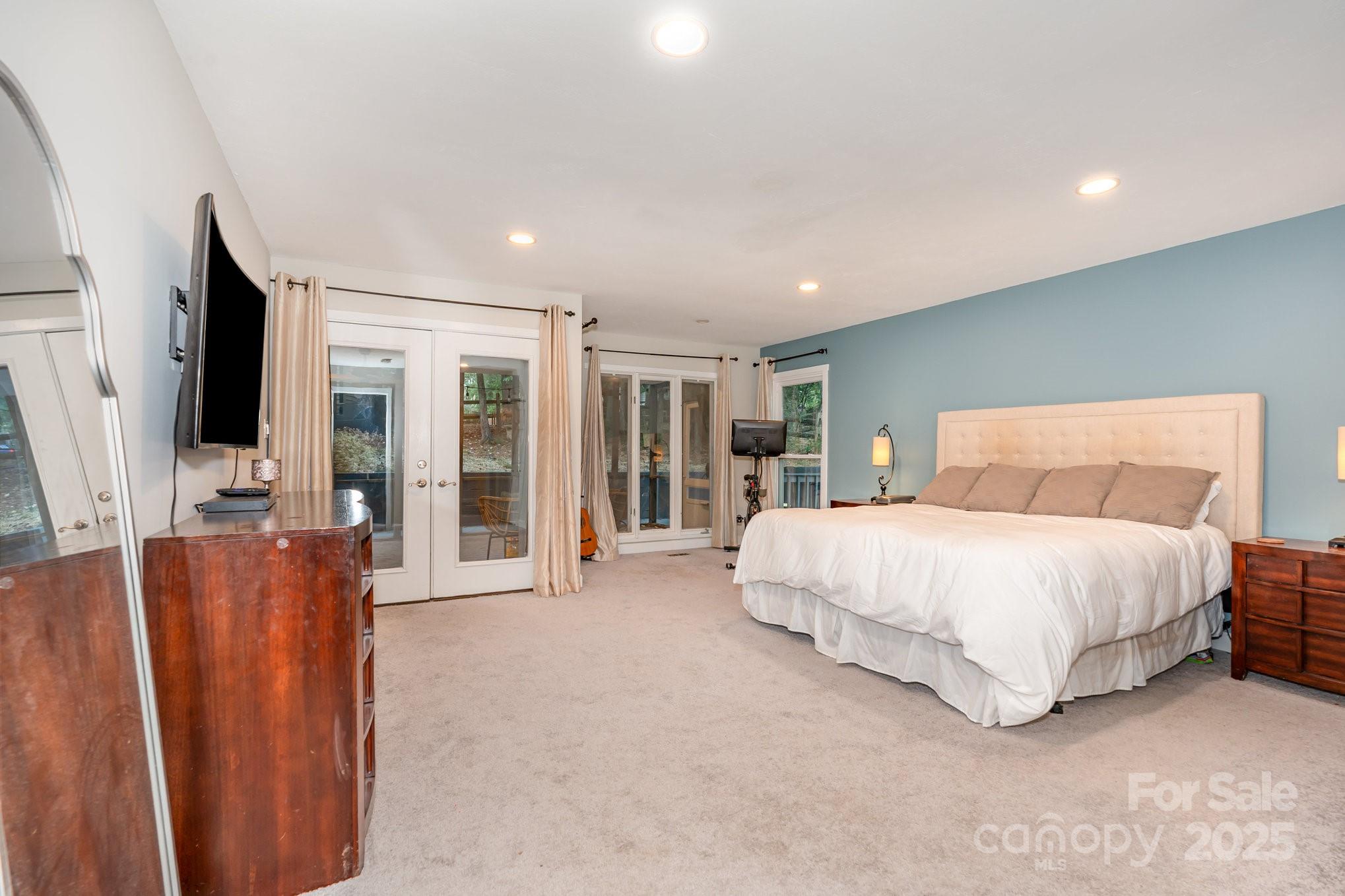 7042 Chelsea Day Lane Tega Cay, SC 29708 - Photo 14 of 40 a spacious bedroom with a large bed and a large window
