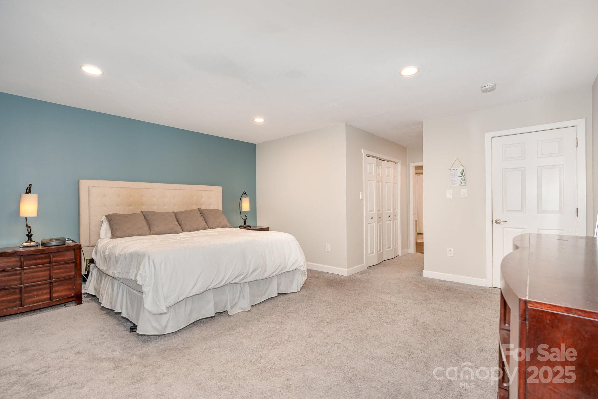 7042 Chelsea Day Lane Tega Cay, SC 29708 - Photo 16 of 40 a spacious bedroom with a bed and a couch