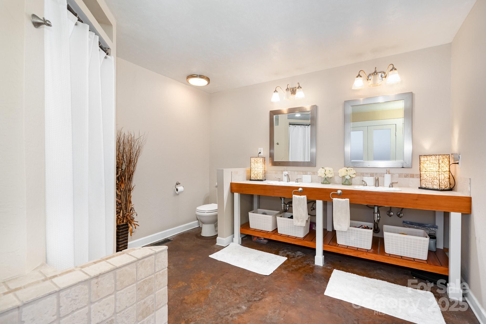 7042 Chelsea Day Lane Tega Cay, SC 29708 - Photo 17 of 40 a bathroom with a double vanity sink and a mirror