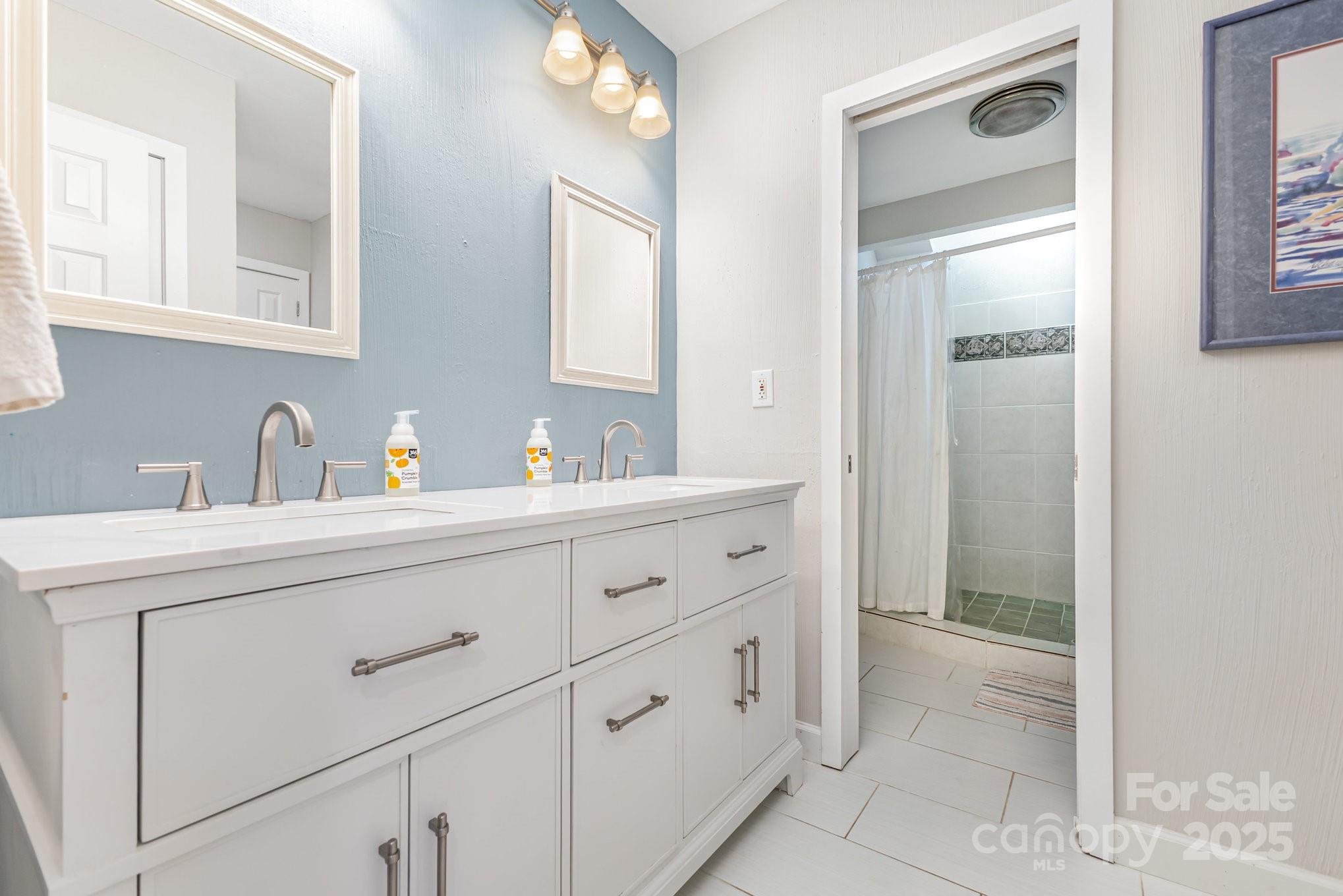 7042 Chelsea Day Lane Tega Cay, SC 29708 - Photo 22 of 40 a bathroom with a sink and a mirror