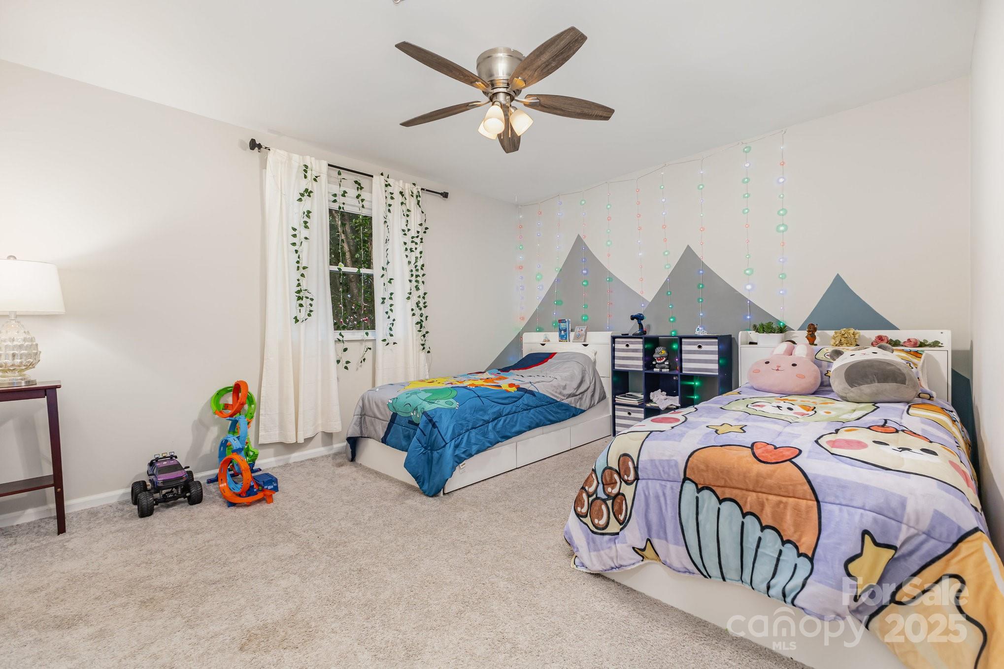 7042 Chelsea Day Lane Tega Cay, SC 29708 - Photo 24 of 40 a bedroom with bed and a chandelier