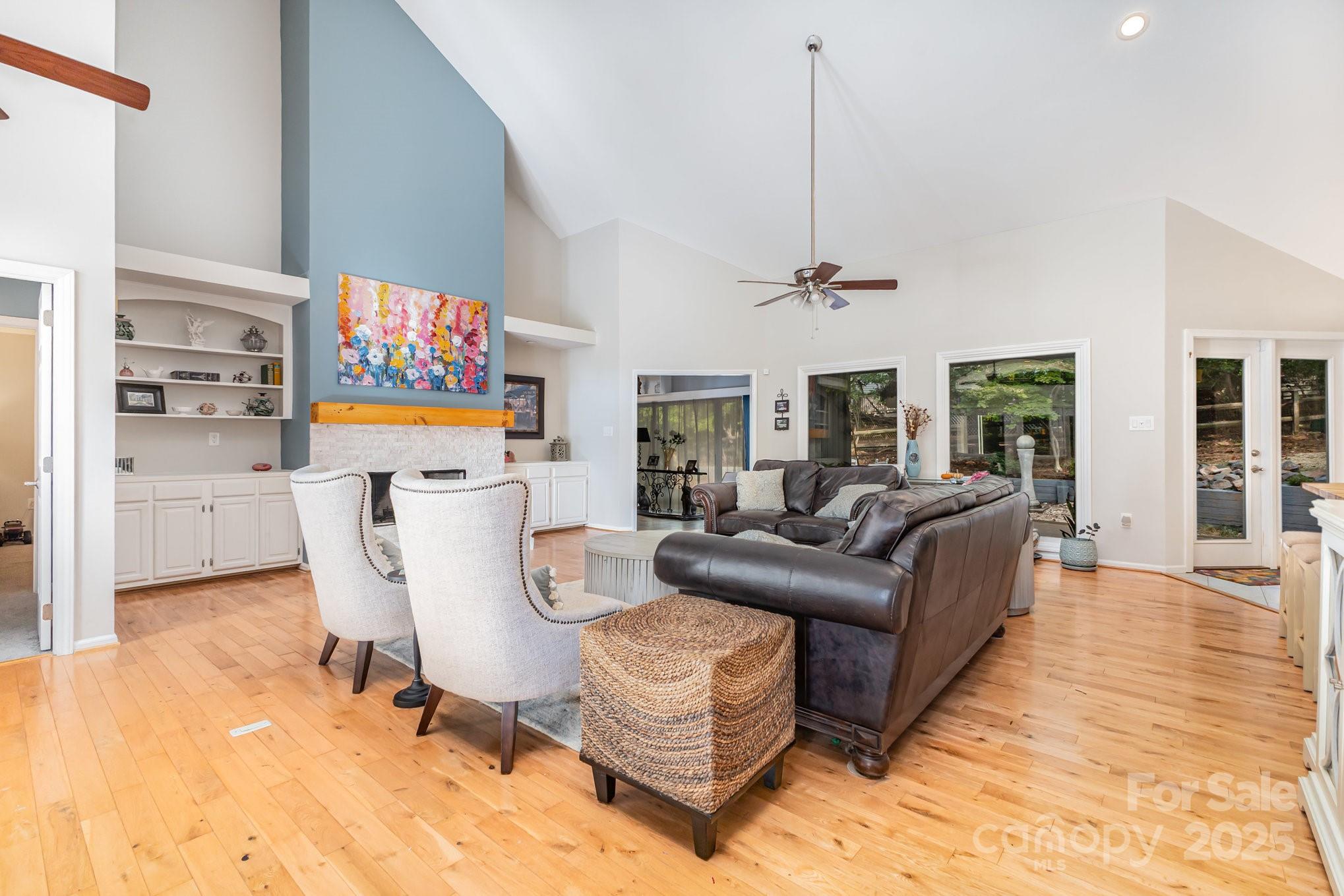 7042 Chelsea Day Lane Tega Cay, SC 29708 - Photo 3 of 40 a living room with furniture a dining table and a painting on the wall