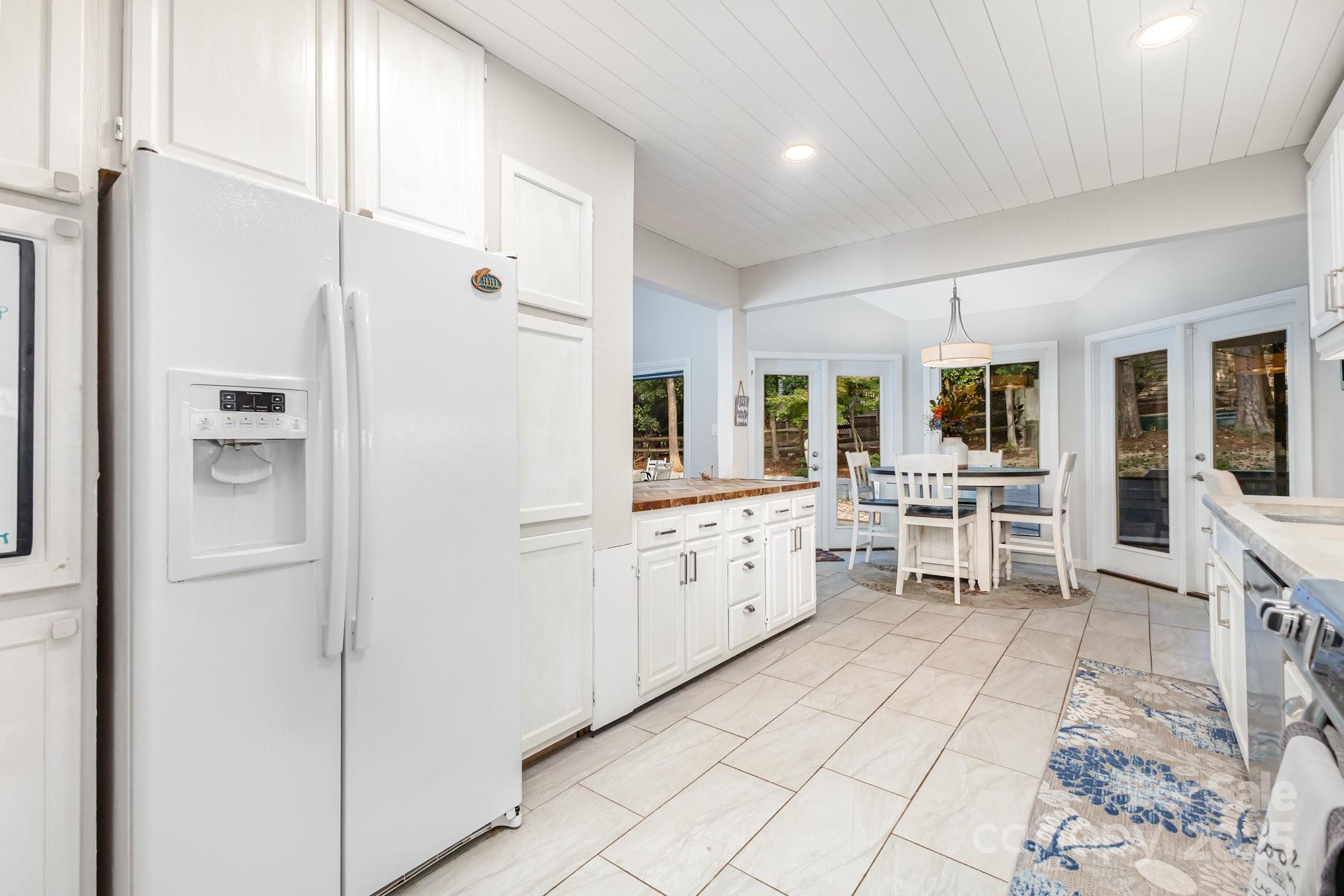 7042 Chelsea Day Lane Tega Cay, SC 29708 - Photo 9 of 40 a kitchen with white cabinets and counter space