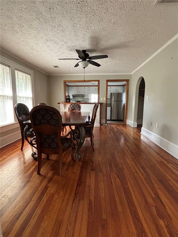 332 Carr Street Athens, GA 30605 - Photo 3 of 8 a dining room with wooden floor a chandelier a wooden table and chairs