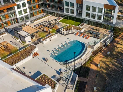 a view of house with swimming pool and outdoor seating