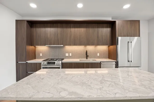 a kitchen with refrigerator and cabinets