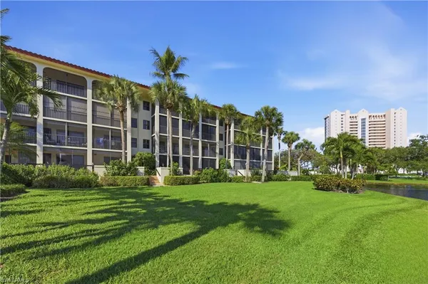 a front view of a building with a garden
