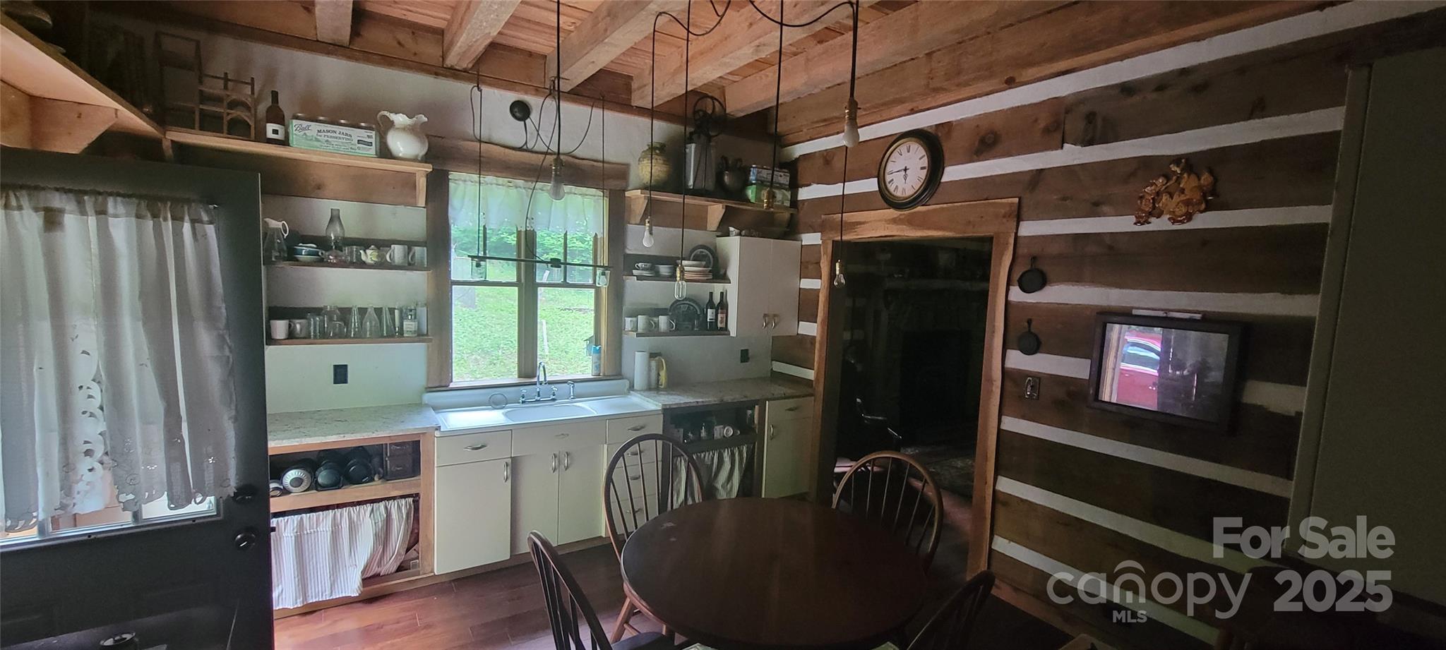 459 Old Yellow Mountain Road Marion, NC 28752 - Photo 19 of 28 a kitchen with stainless steel appliances granite countertop a refrigerator a stove and a wooden floors