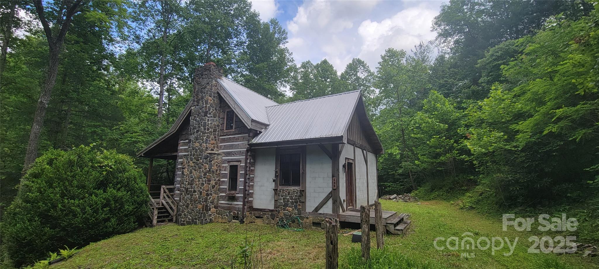 459 Old Yellow Mountain Road Marion, NC 28752 - Photo 4 of 28 front view of a house with a garden