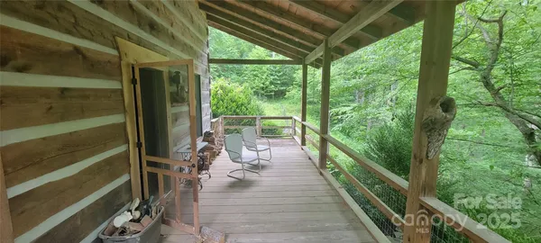 a view of balcony with chairs and wooden fence