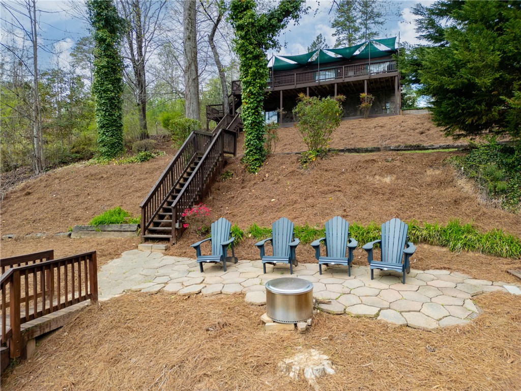 203 Little Lane Seneca, SC 29672 - Photo 45 of 48 This serene outdoor space features a natural landscape with a fire pit and inviting seating.