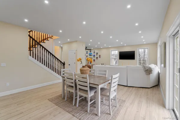 a view of a dining room with furniture wooden floor and windows