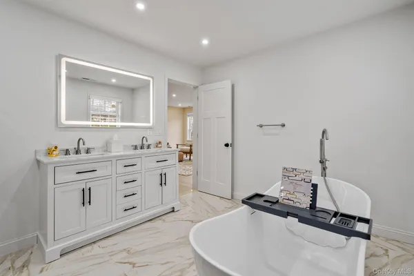 a bathroom with a double vanity sink mirror and