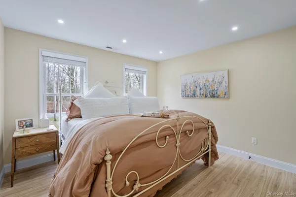 a bedroom with a bed and a painting on the wall
