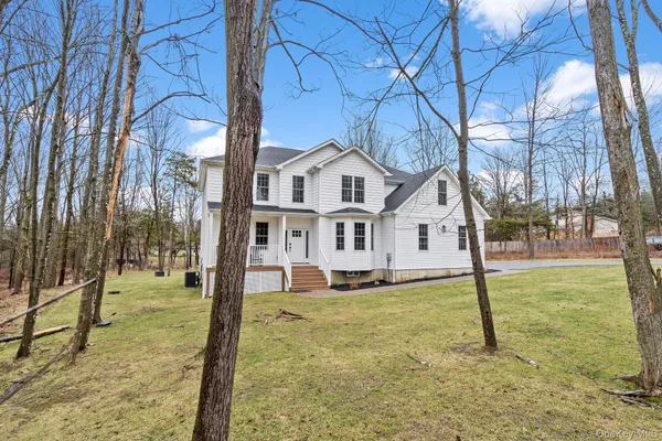 a house that has a tree in front of it