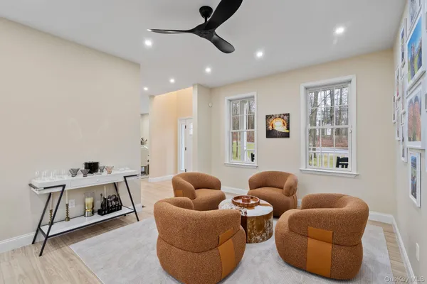 a living room with furniture a ceiling fan and a window