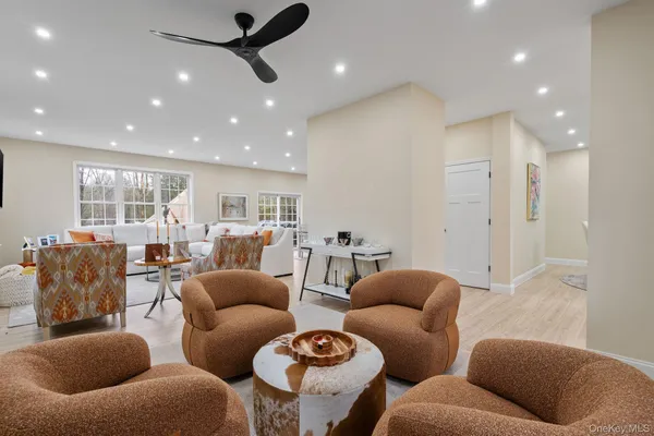 a living room with furniture and a glass door
