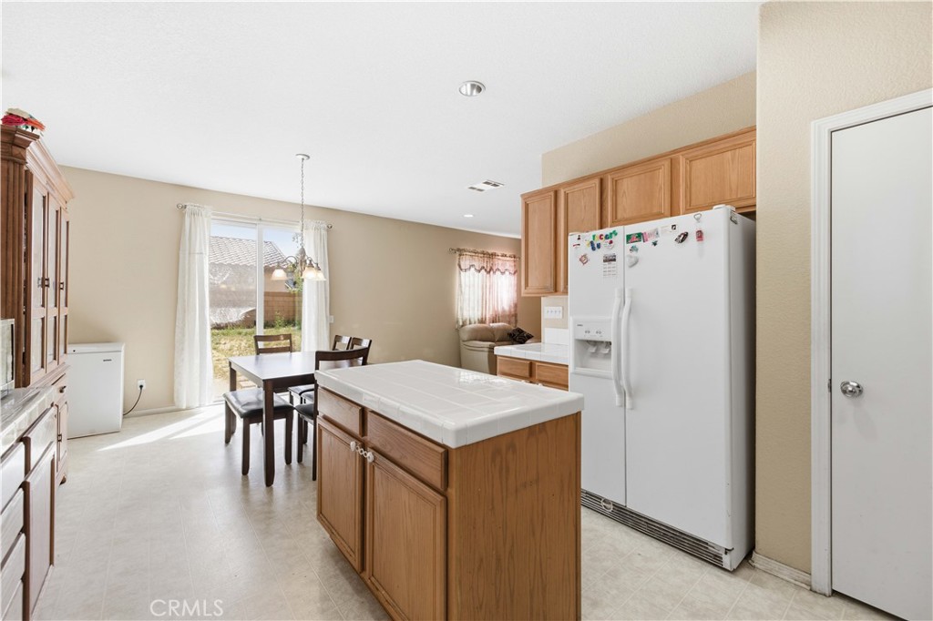 2822 Emerald Lane Lancaster, CA 93535 - Photo 11 of 29 a kitchen with refrigerator and furniture
