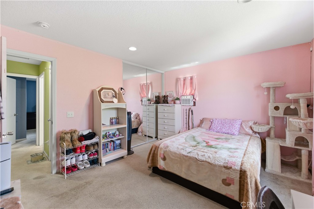 2822 Emerald Lane Lancaster, CA 93535 - Photo 19 of 29 a bedroom with a bed and a chandelier