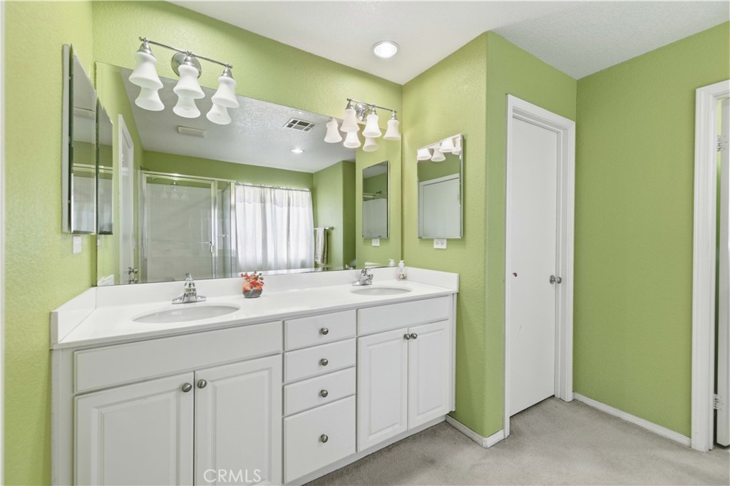 2822 Emerald Lane Lancaster, CA 93535 - Photo 25 of 29 a spacious bathroom with a double vanity sink mirror and double