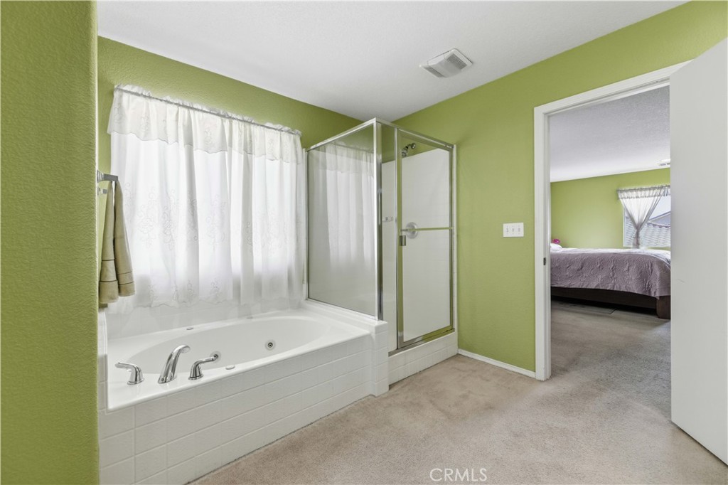 2822 Emerald Lane Lancaster, CA 93535 - Photo 26 of 29 a bathroom with a tub and a shower