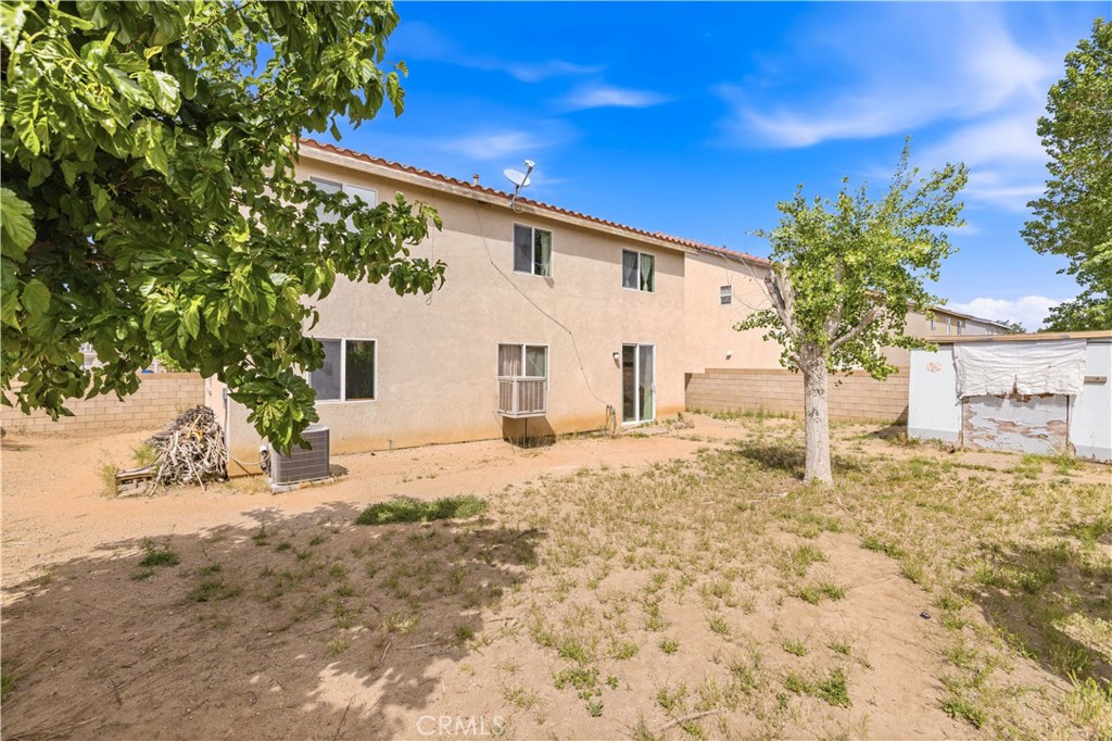 2822 Emerald Lane Lancaster, CA 93535 - Photo 27 of 29 a view of a white house with a yard