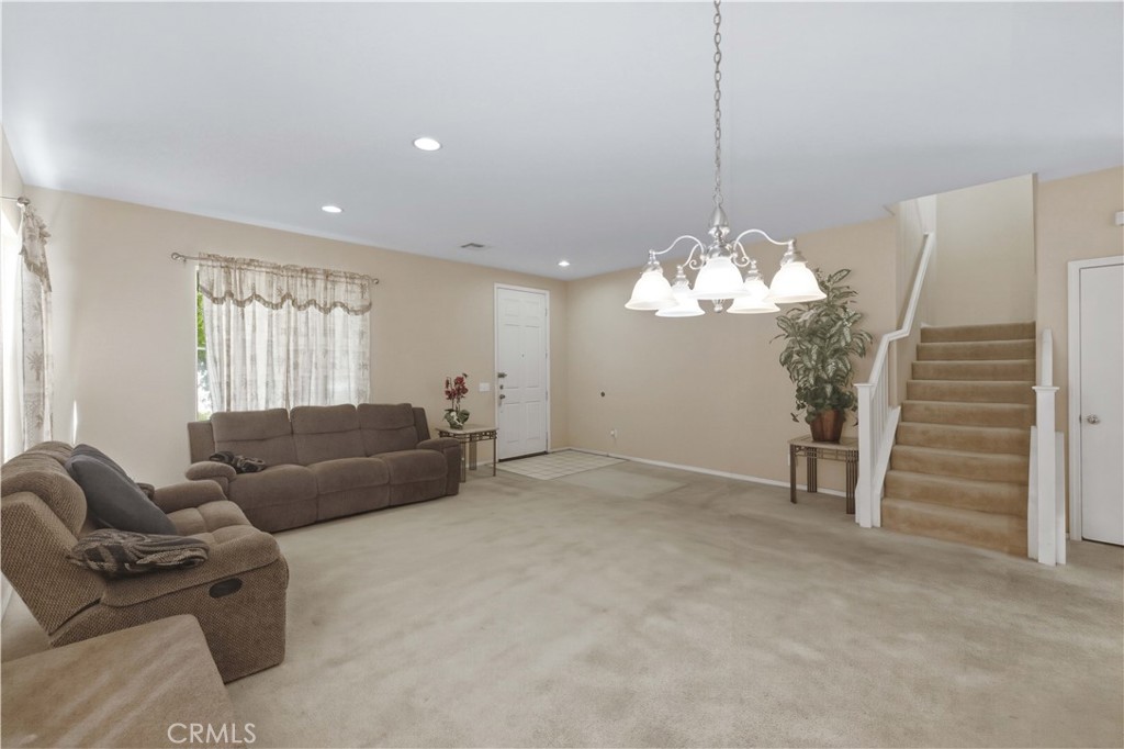 2822 Emerald Lane Lancaster, CA 93535 - Photo 4 of 29 a living room with furniture and a chandelier