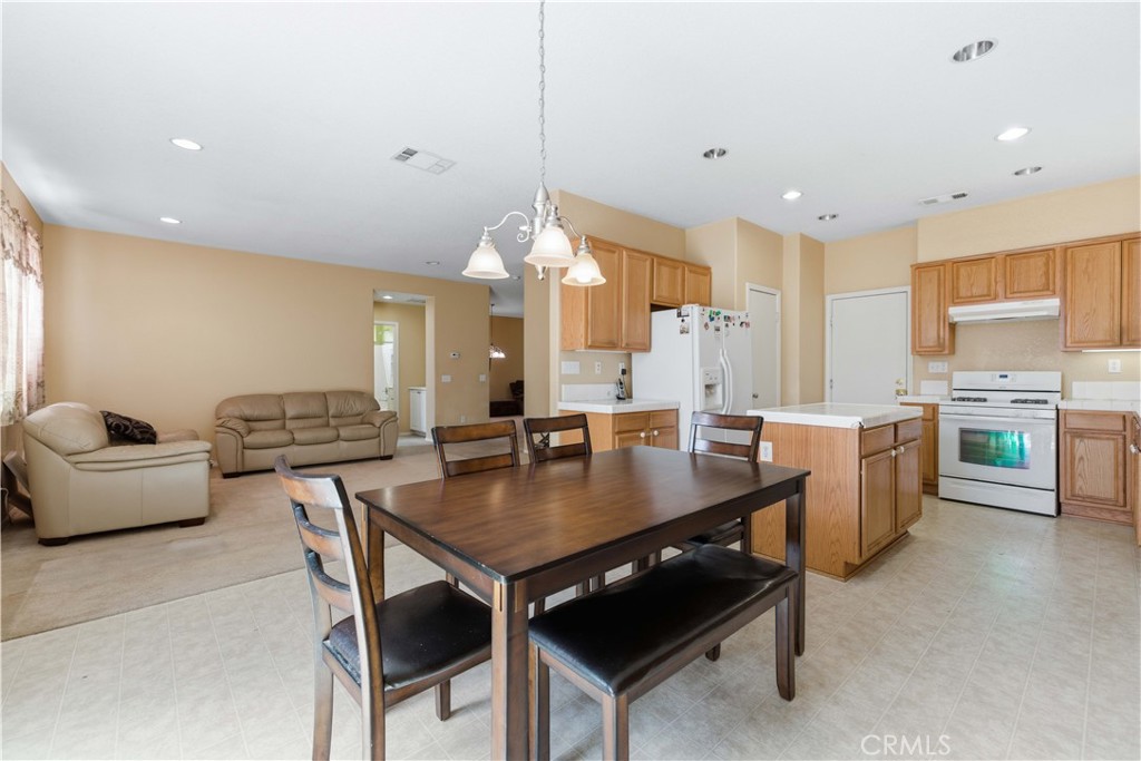 2822 Emerald Lane Lancaster, CA 93535 - Photo 9 of 29 a kitchen with a table chairs and wooden floor