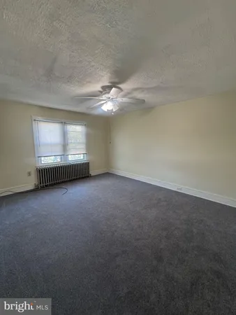 a view of a room with an empty space and a window