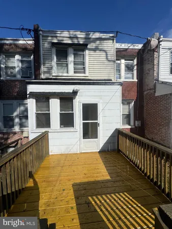 a view of a house with wooden fence