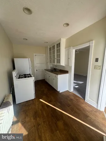 a kitchen with a refrigerator and a stove top oven