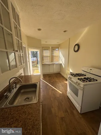 a kitchen with a stove a sink and a refrigerator