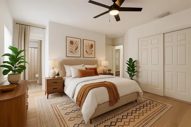 a bedroom with a bed and a potted plant