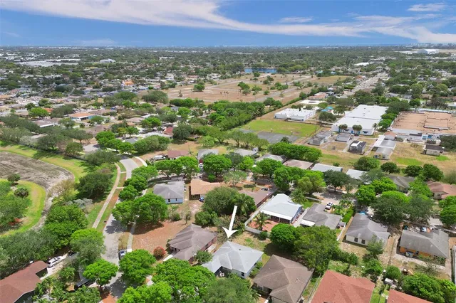 an aerial view of residential houses with city view