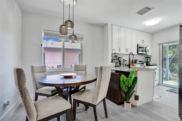 a view of a dining room with furniture and window