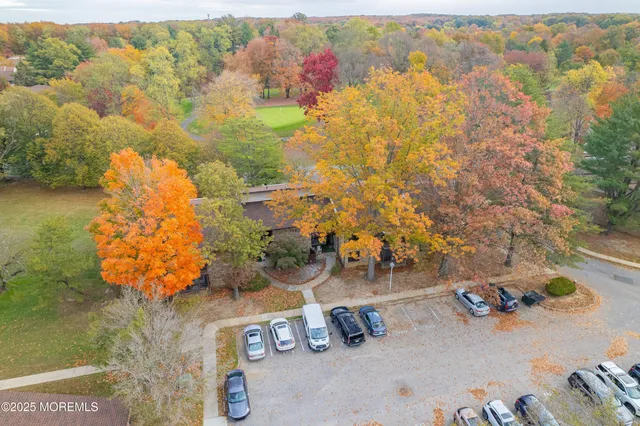 an aerial view of a house with swimming pool and ocean view