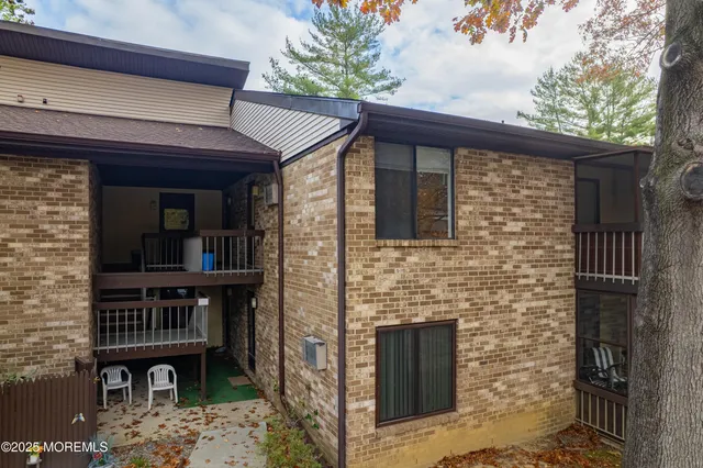 a view of a house with a patio and a fire pit