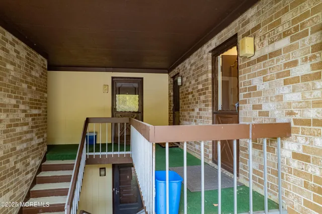 a view of house with deck and furniture