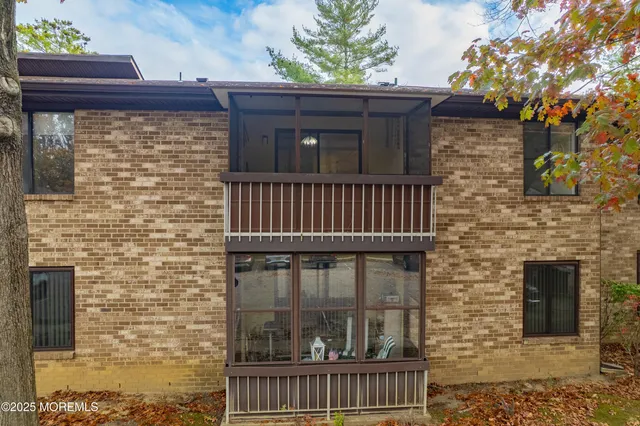 a view of a brick house with a large window