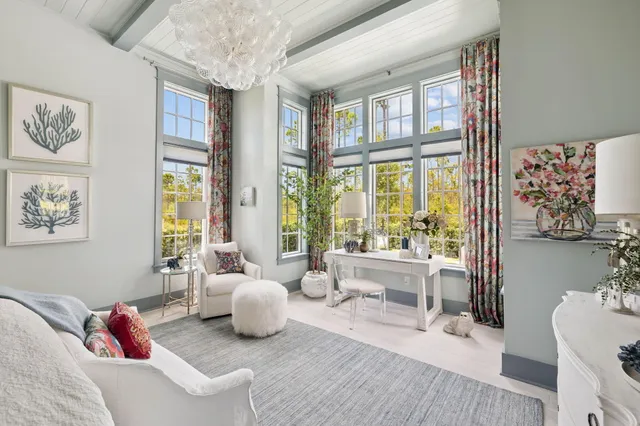 a view of a livingroom with furniture and floor to ceiling window
