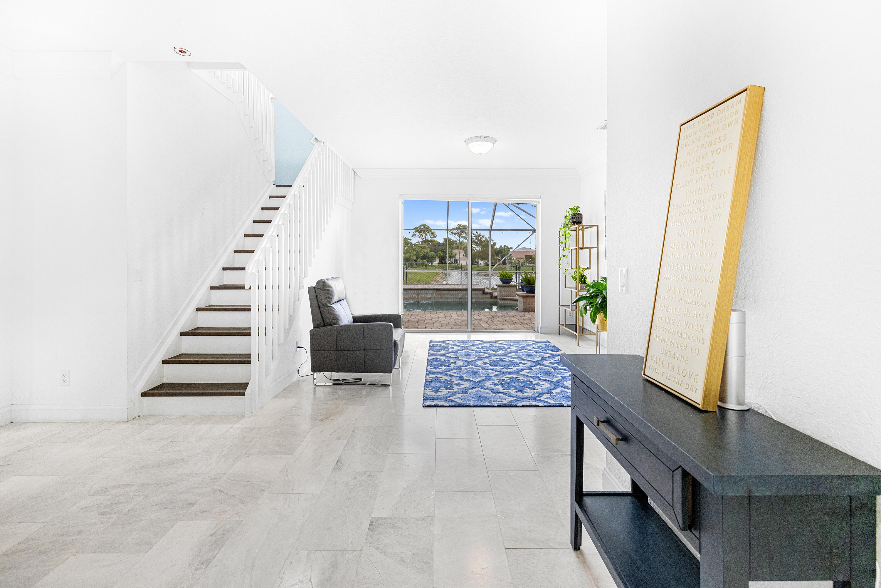 6575 Spring Meadow Drive Greenacres, FL 33413 - Photo 2 of 51 a view of wooden floor and windows in a room